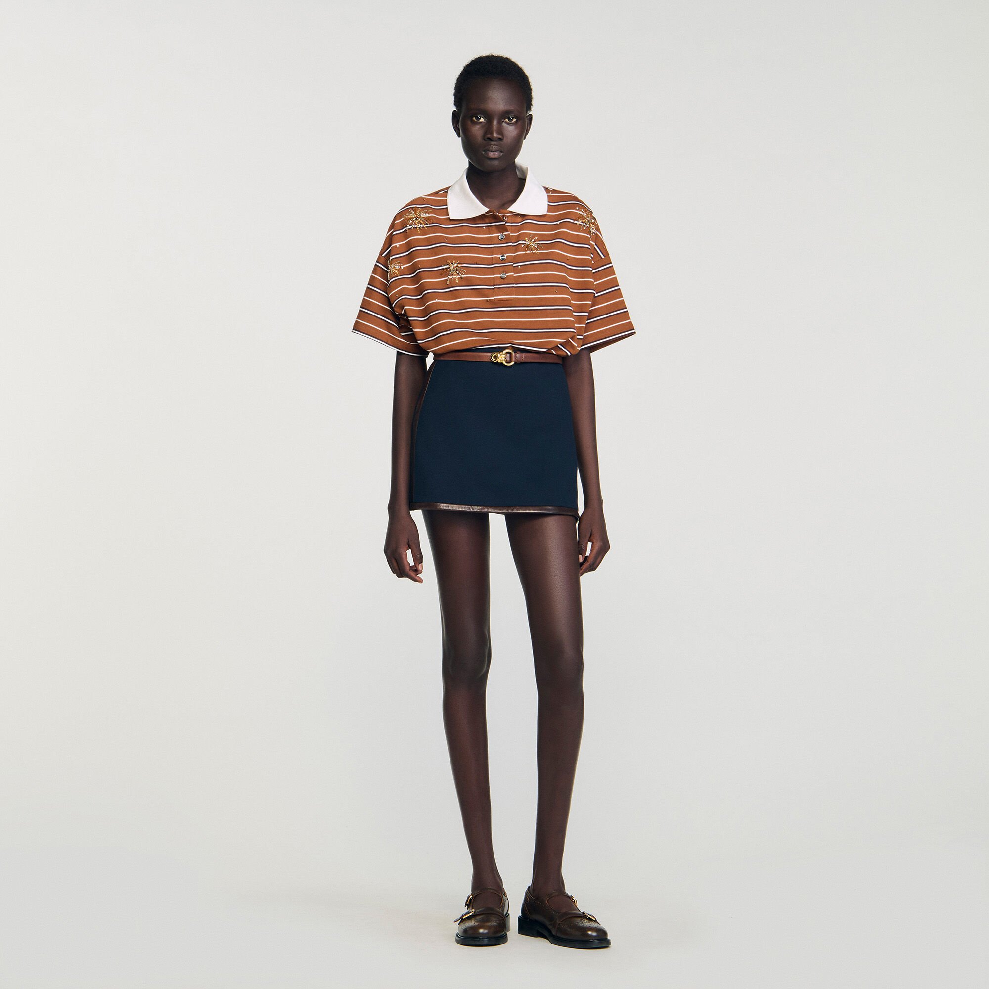 Short skirt with leather bands