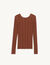 Sweater with twist and ring at the back