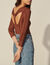 Sweater with twist and ring at the back