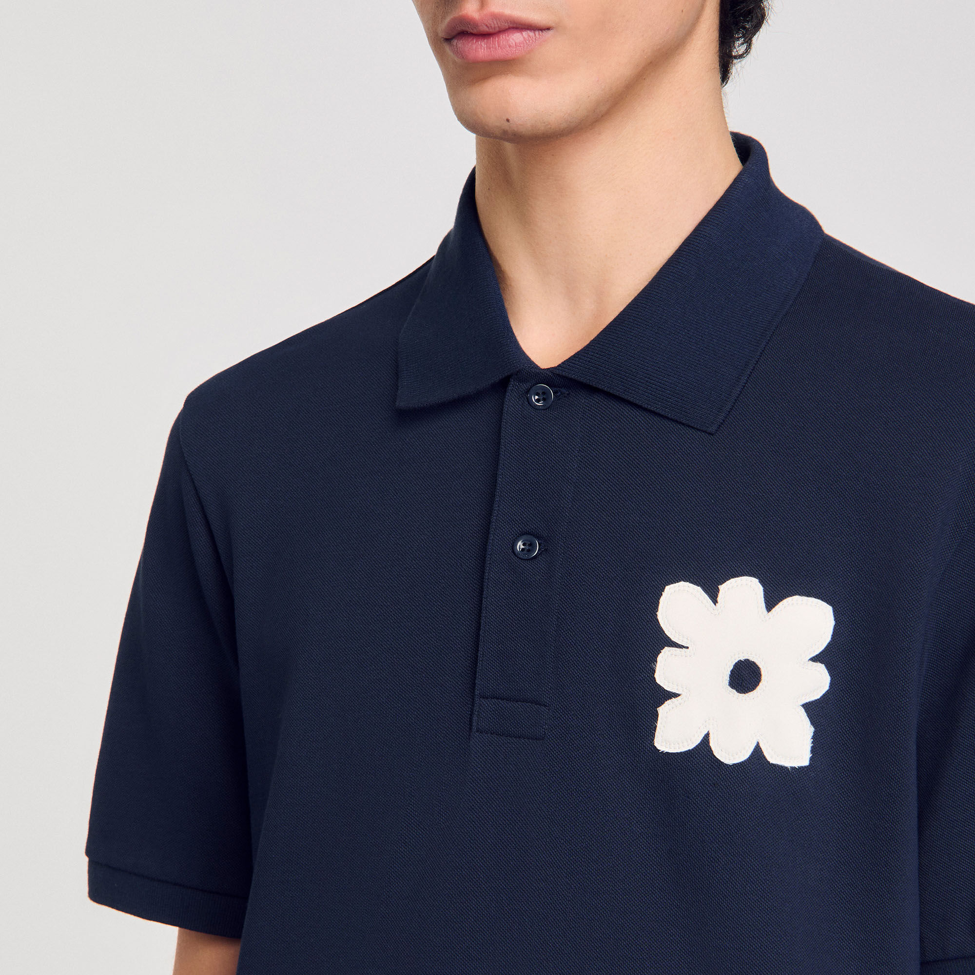 Polo shirt with flower patch