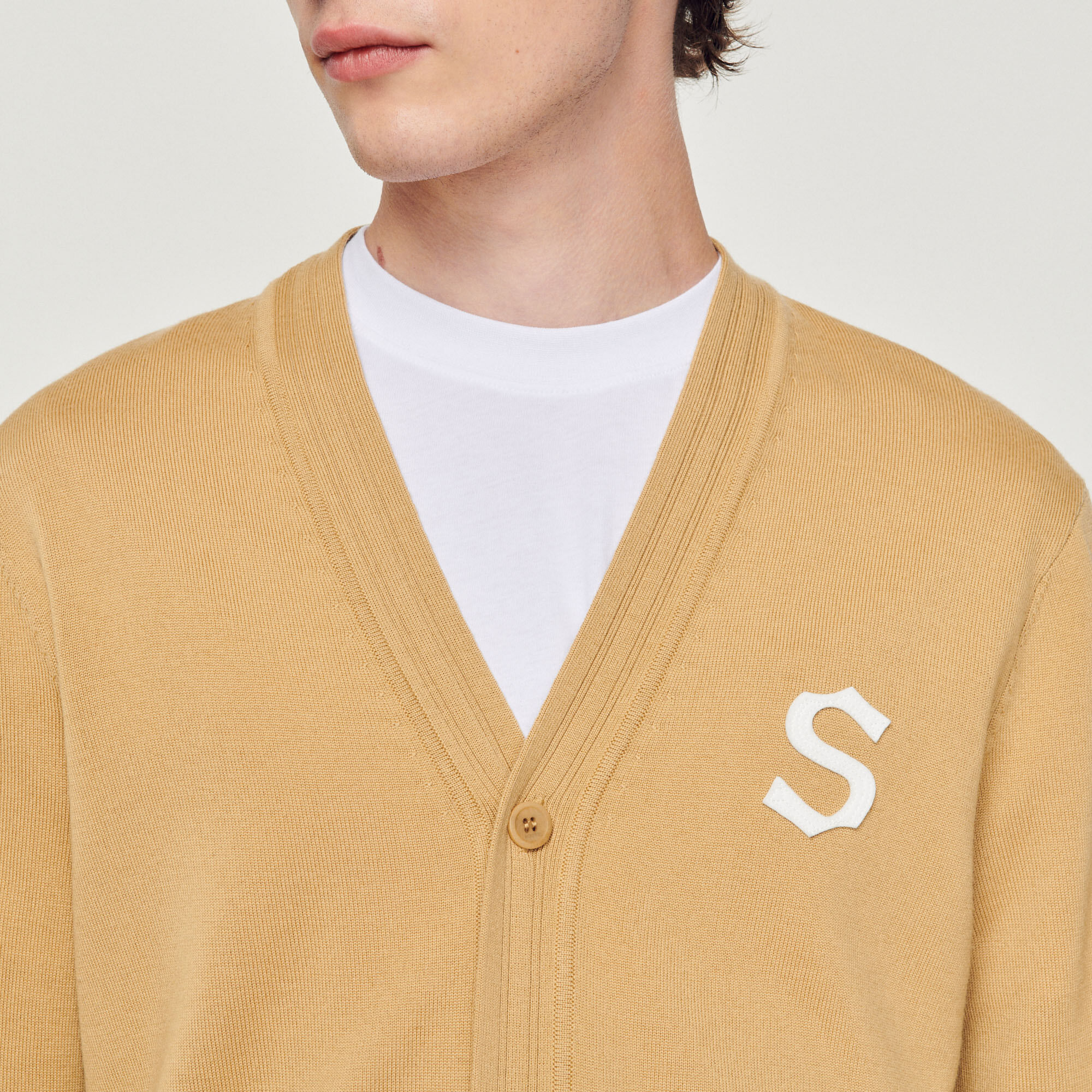 Wool cardigan with S patch