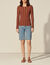 Sweater with twist and ring at the back