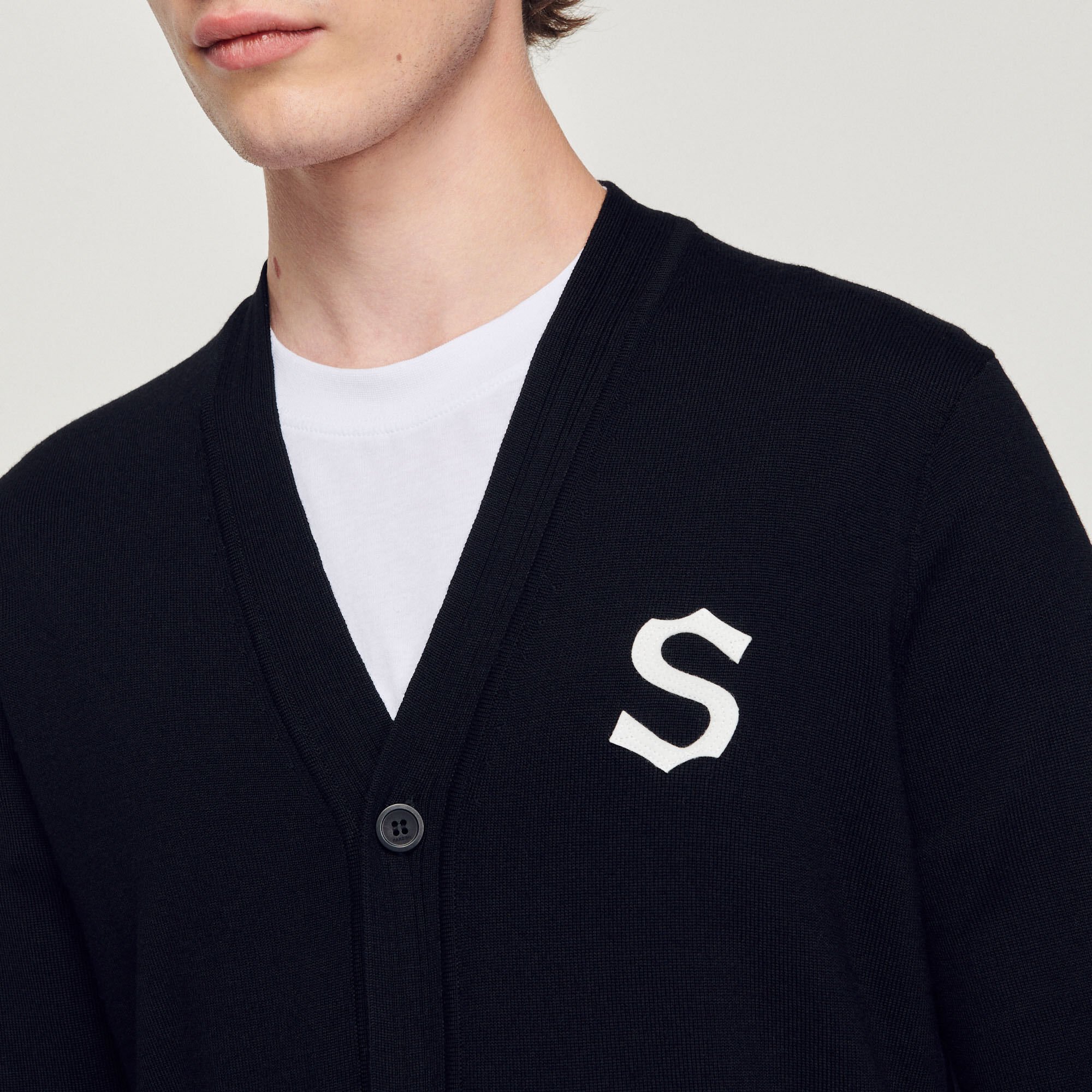 Wool cardigan with S patch